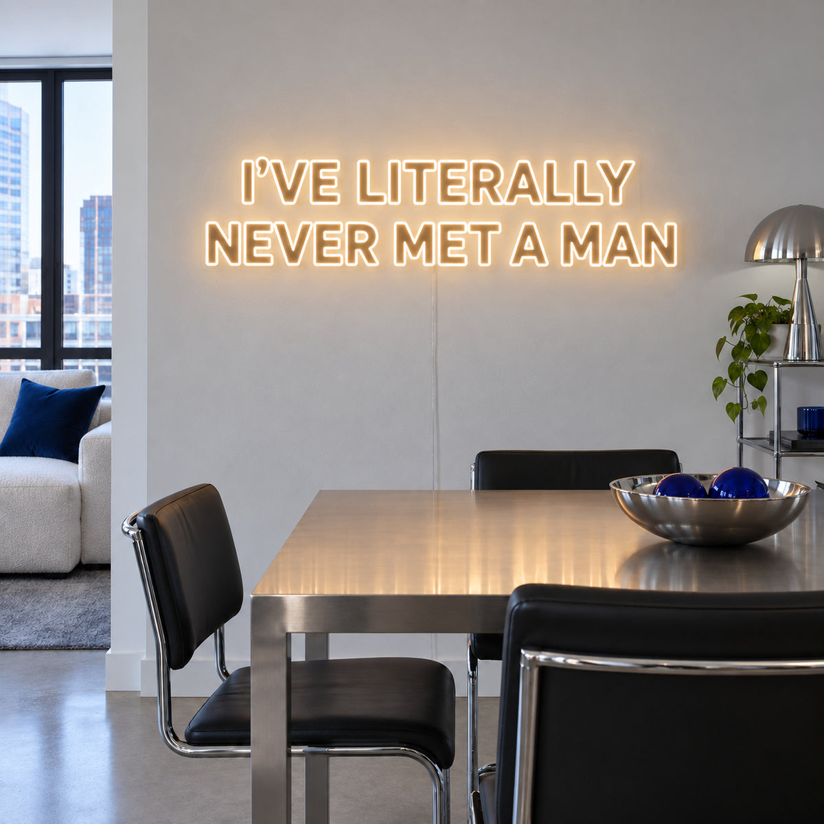 Warm White version of the I've Literally Never Met A Man Neon Sign, shown above a dining table.