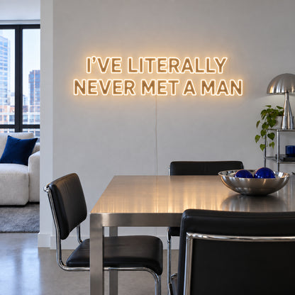 Warm White version of the I've Literally Never Met A Man Neon Sign, shown above a dining table.