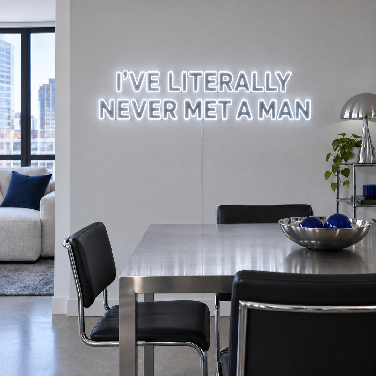 I've Literally Never Met A Man Neon Sign glowing white above a dining table.