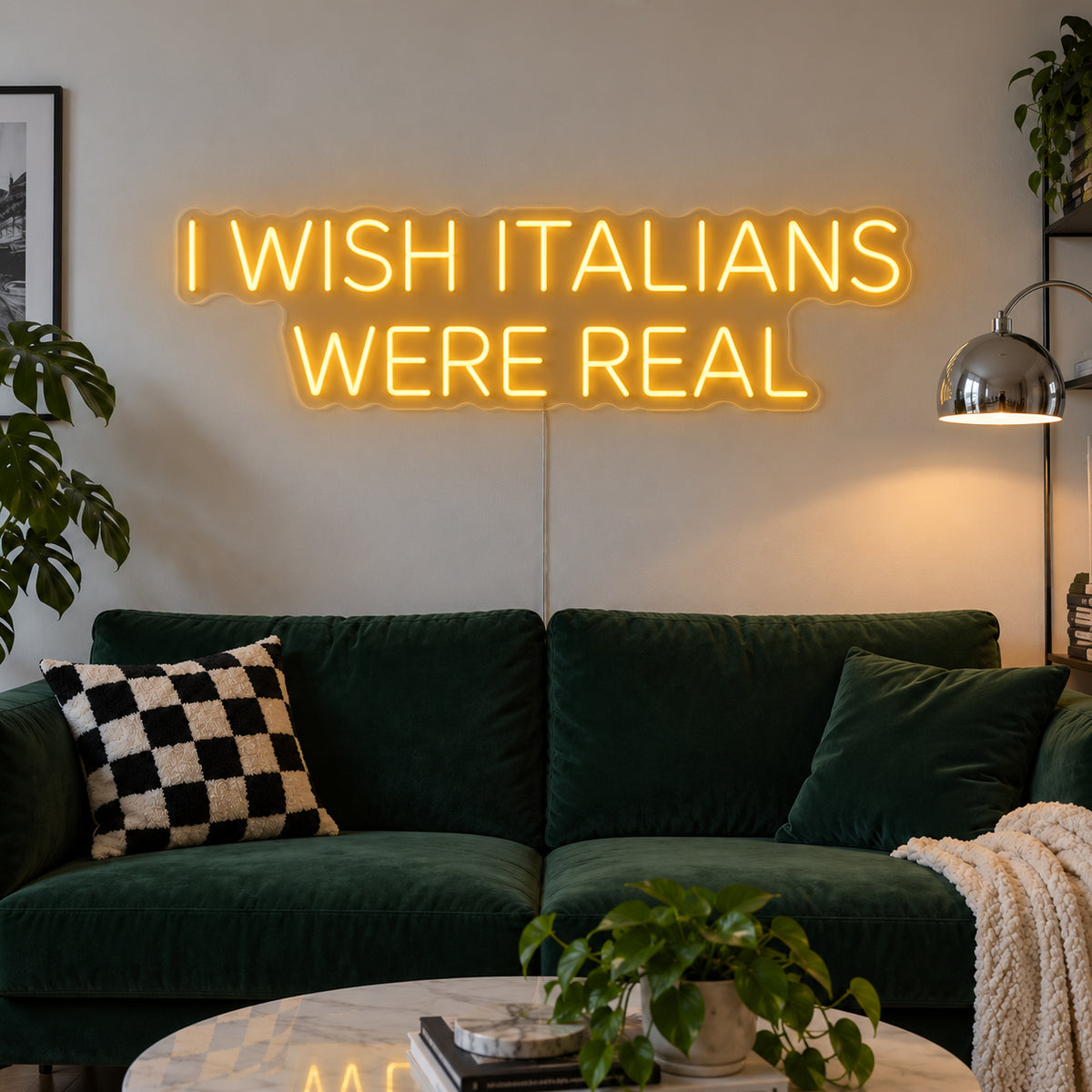 I Wish Italians Were Real Neon Sign glowing gold above a green sofa.