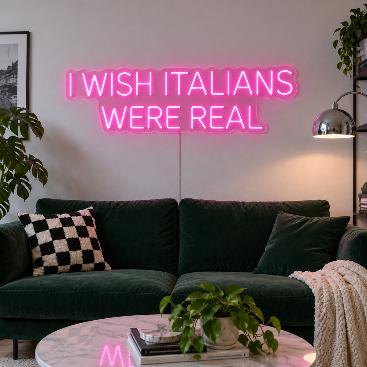 Rose Red version of the I Wish Italians Were Real Neon Sign, shown above a green sofa.