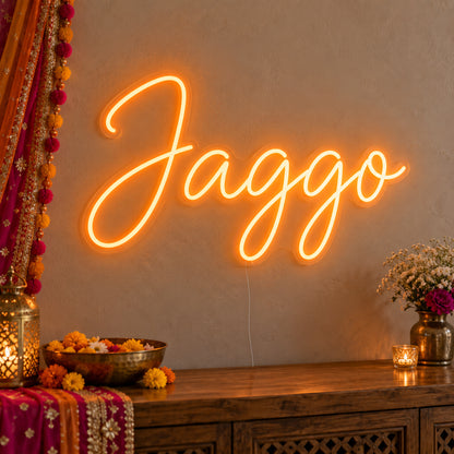 Jaggo Neon Sign on clear cut-to-shape acrylic, illuminated on a wall in a styled celebration setting