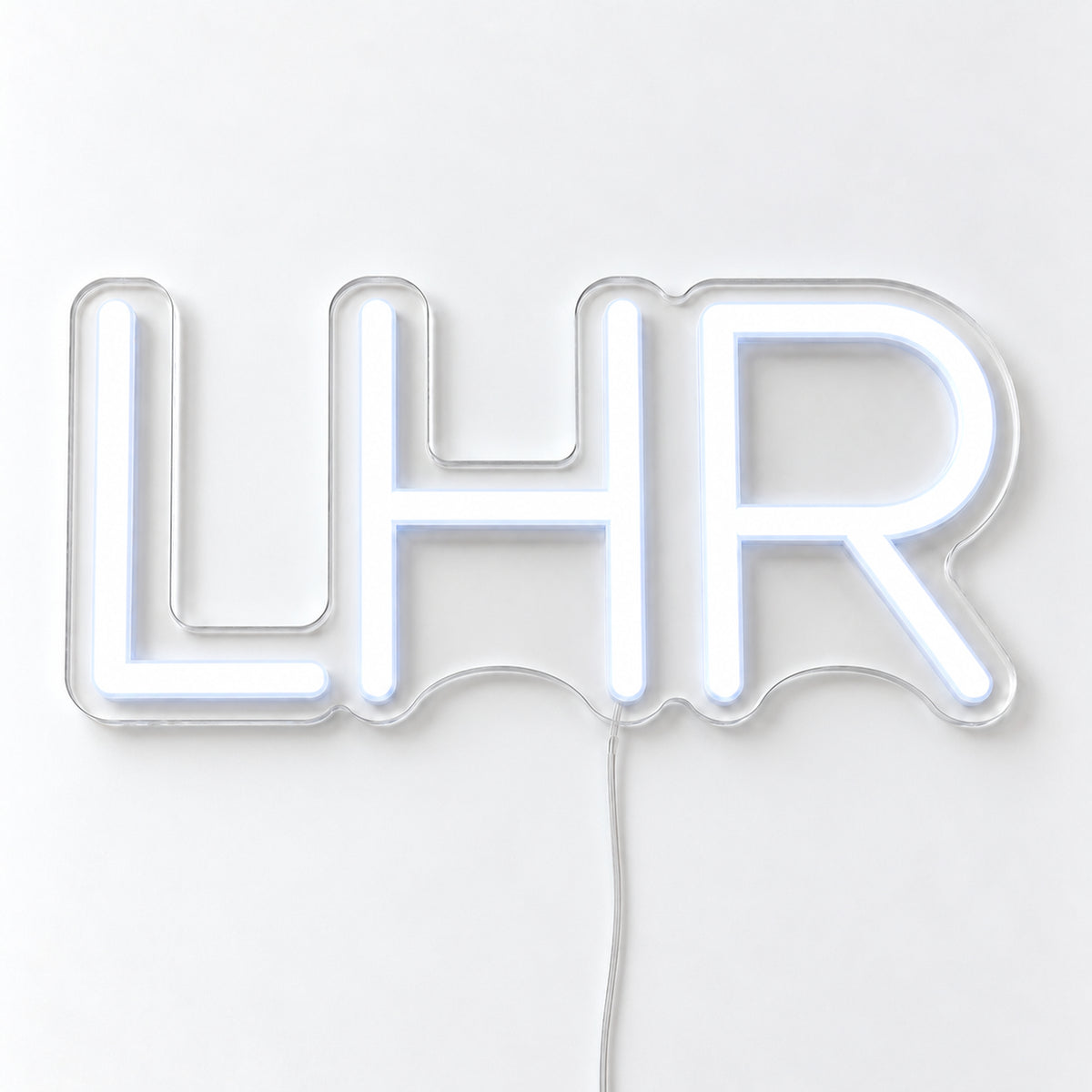 LHR Airport Code Neon Sign with LED lettering on one contour-cut clear acrylic backing, displayed on a white surface