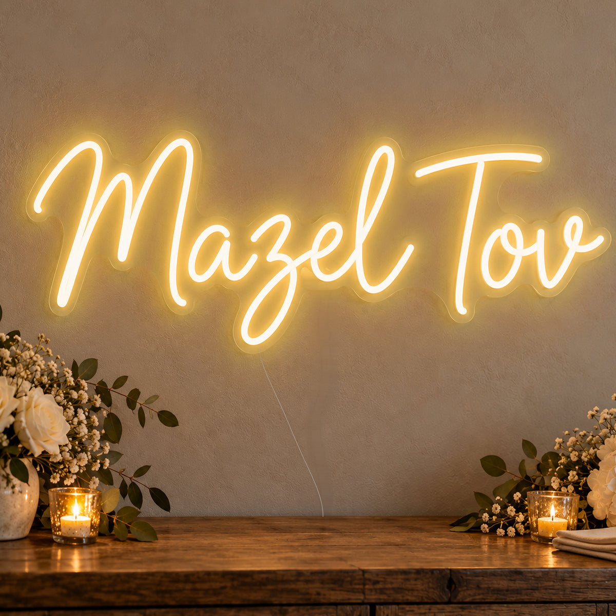 Mazel Tov Neon Sign in gold LED neon on clear acrylic, angled view