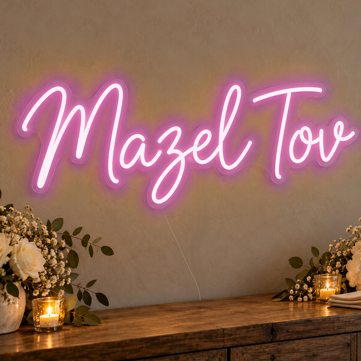 Mazel Tov Neon Sign in pink LED neon on clear acrylic, angled view