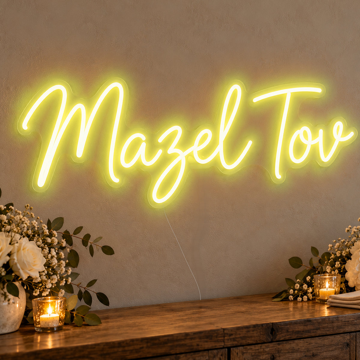 Mazel Tov Neon Sign in yellow LED neon on clear acrylic, angled view