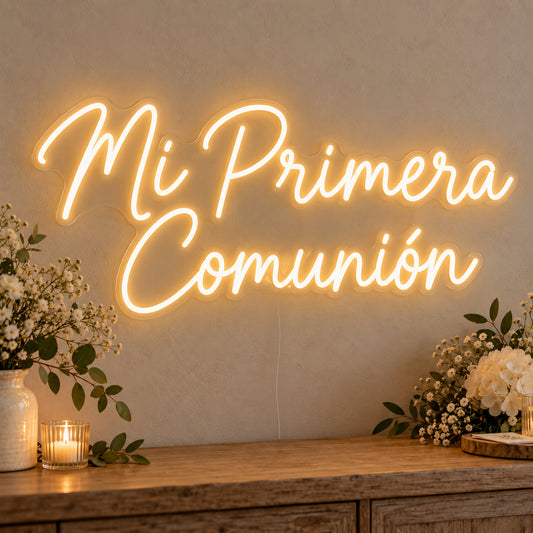 Mi Primera Comunión Neon Sign on clear cut-to-shape acrylic, illuminated on a wall in a styled celebration setting