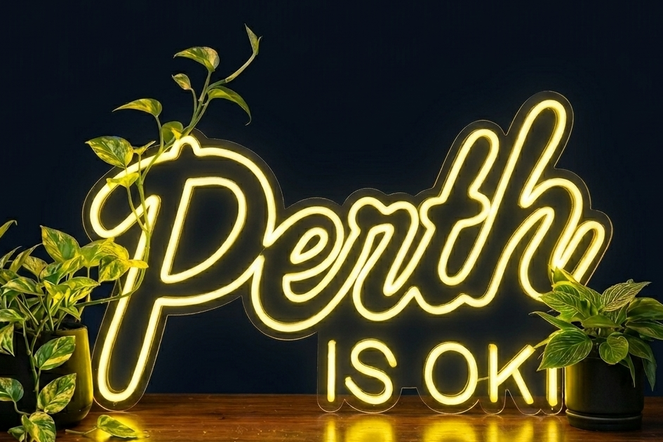 Perth is OK! neon sign on a dark background with plants, shown as custom sign inspiration for Fremantle.