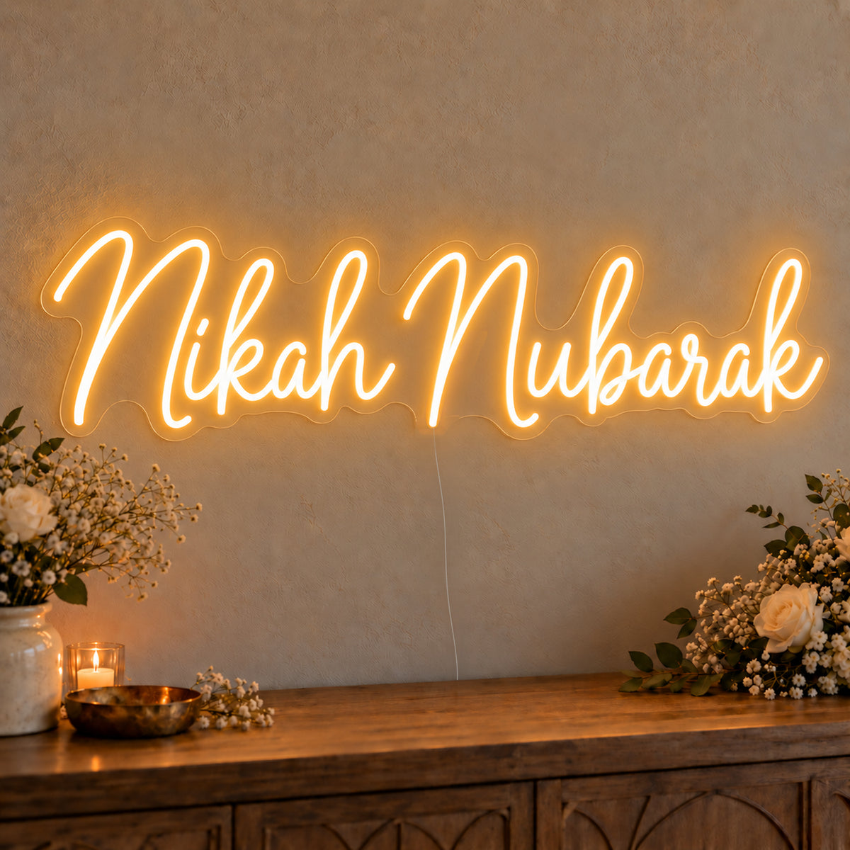 Nikah Mubarak Neon Sign on clear cut-to-shape acrylic, illuminated on a wall in a styled celebration setting