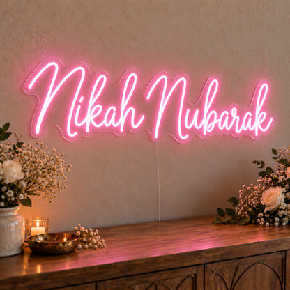 Nikah Mubarak Neon Sign in pink LED neon on clear acrylic, angled view