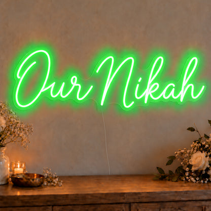Our Nikah Neon Sign in green LED neon on clear acrylic, angled view