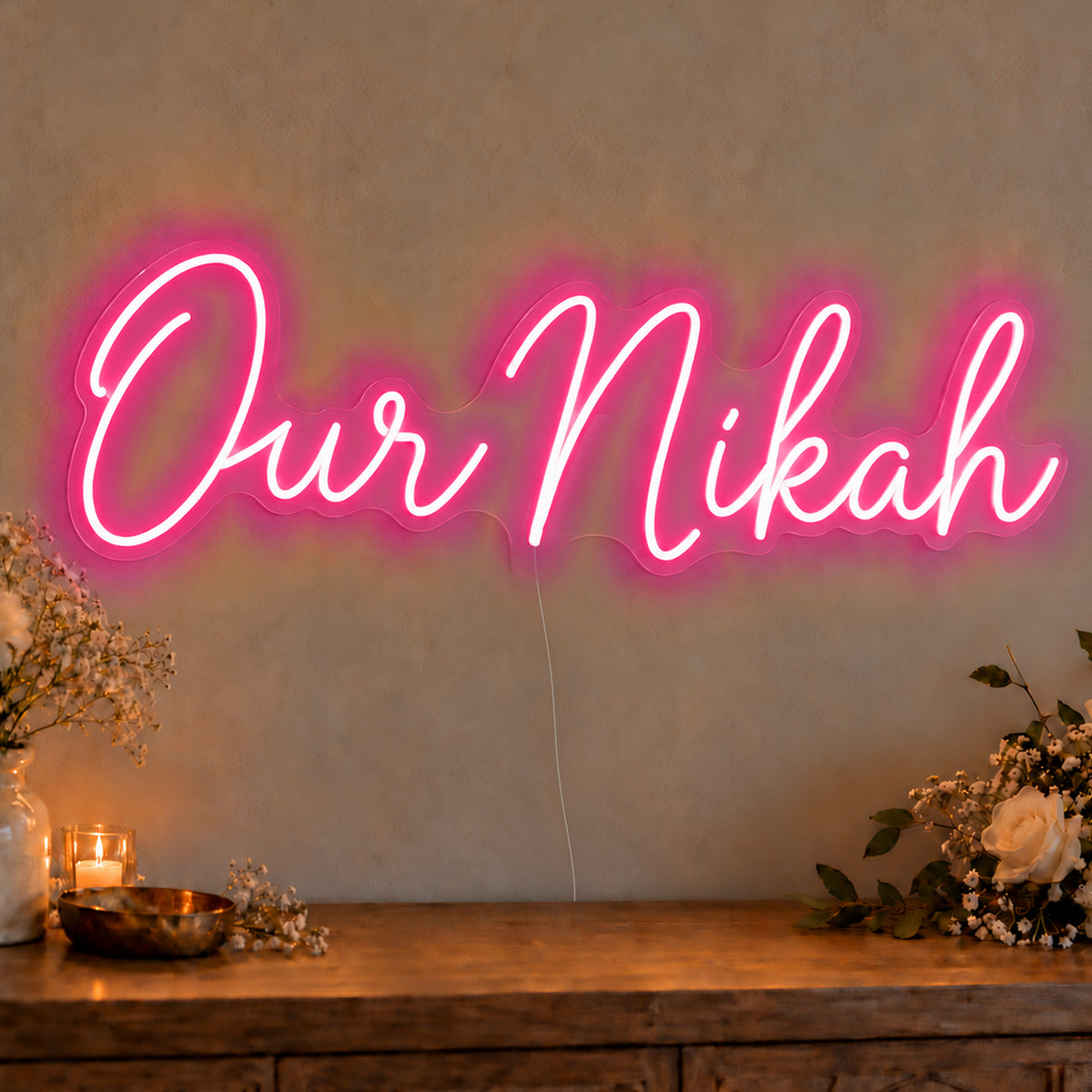 Our Nikah Neon Sign in rose red LED neon on clear acrylic, angled view