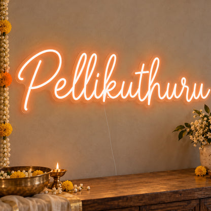 Pellikuthuru Neon Sign in orange LED neon on clear acrylic, angled view