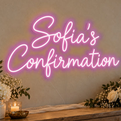 Personalised Confirmation Neon Sign in pink LED neon on clear acrylic, angled view