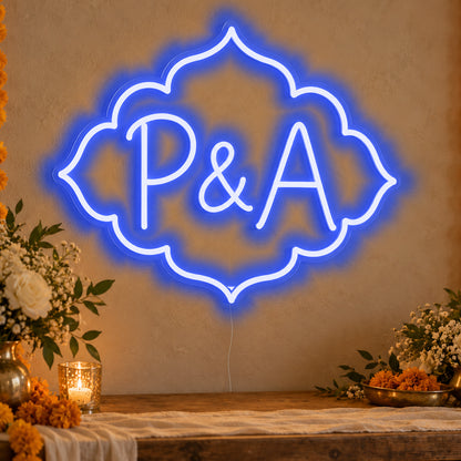 Personalised Marigold Initials Neon Sign in blue LED neon on clear acrylic, angled view