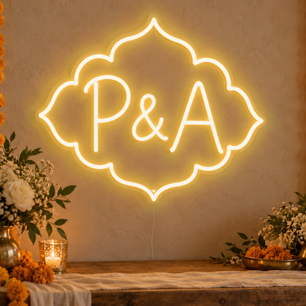 Personalised Marigold Initials Neon Sign in gold LED neon on clear acrylic, angled view