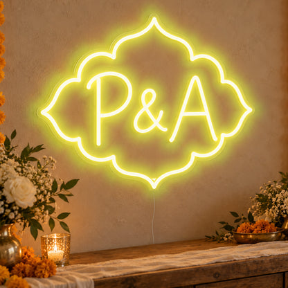 Personalised Marigold Initials Neon Sign in yellow LED neon on clear acrylic, angled view