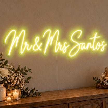 Personalised Mr & Mrs Surname Neon Sign in yellow LED neon on clear acrylic, angled view