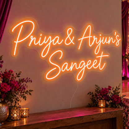 Personalised Sangeet Neon Sign in orange LED neon on clear acrylic, angled view