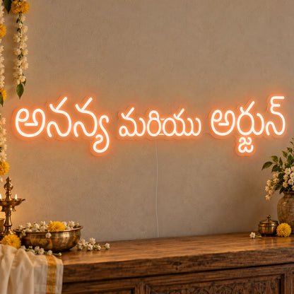Personalised Telugu Couple Names Neon Sign in orange LED neon on clear acrylic, angled view