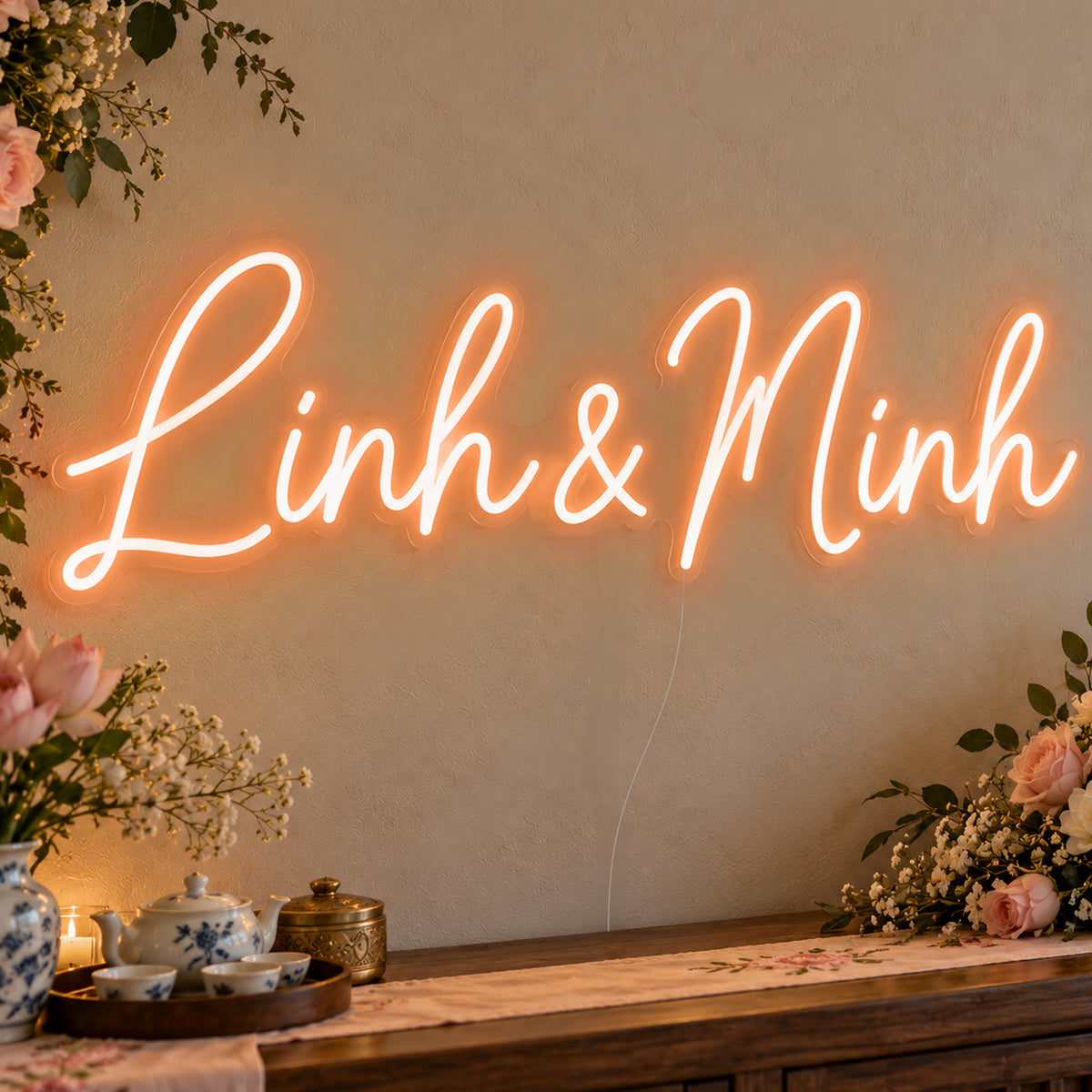 Personalised Vietnamese Couple Names Neon Sign in orange LED neon on clear acrylic, angled view