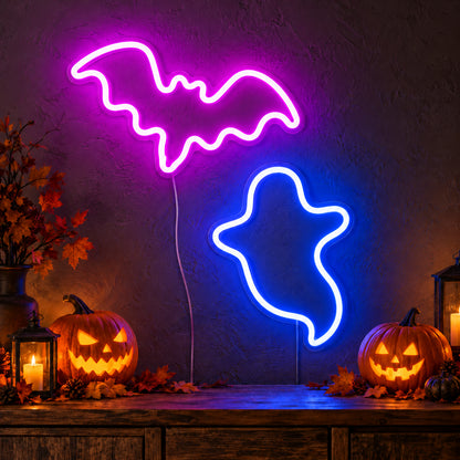 Pink Bat and Blue Ghost Neon Sign featuring a bright pink bat above a blue ghost outline, glowing on a dark wall in a Halloween room display.
