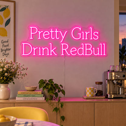 Pretty Girls Drink RedBull Neon Sign glowing pink above a kitchen counter.