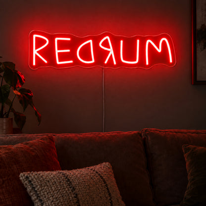 Redrum Neon Sign featuring red Redrum lettering with reversed letter details, glowing on a dark living room wall.