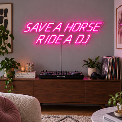 Rose Red version of the Save A Horse Ride A DJ Neon Sign, shown above a turntable on a wooden sideboard.