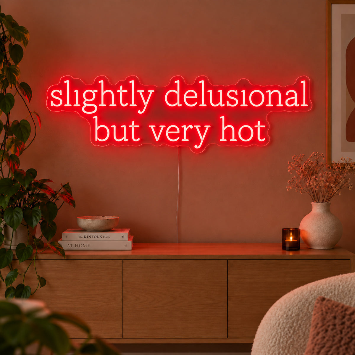 Slightly Delusional But Very Hot Neon Sign with red lighting, displayed above a wooden sideboard.