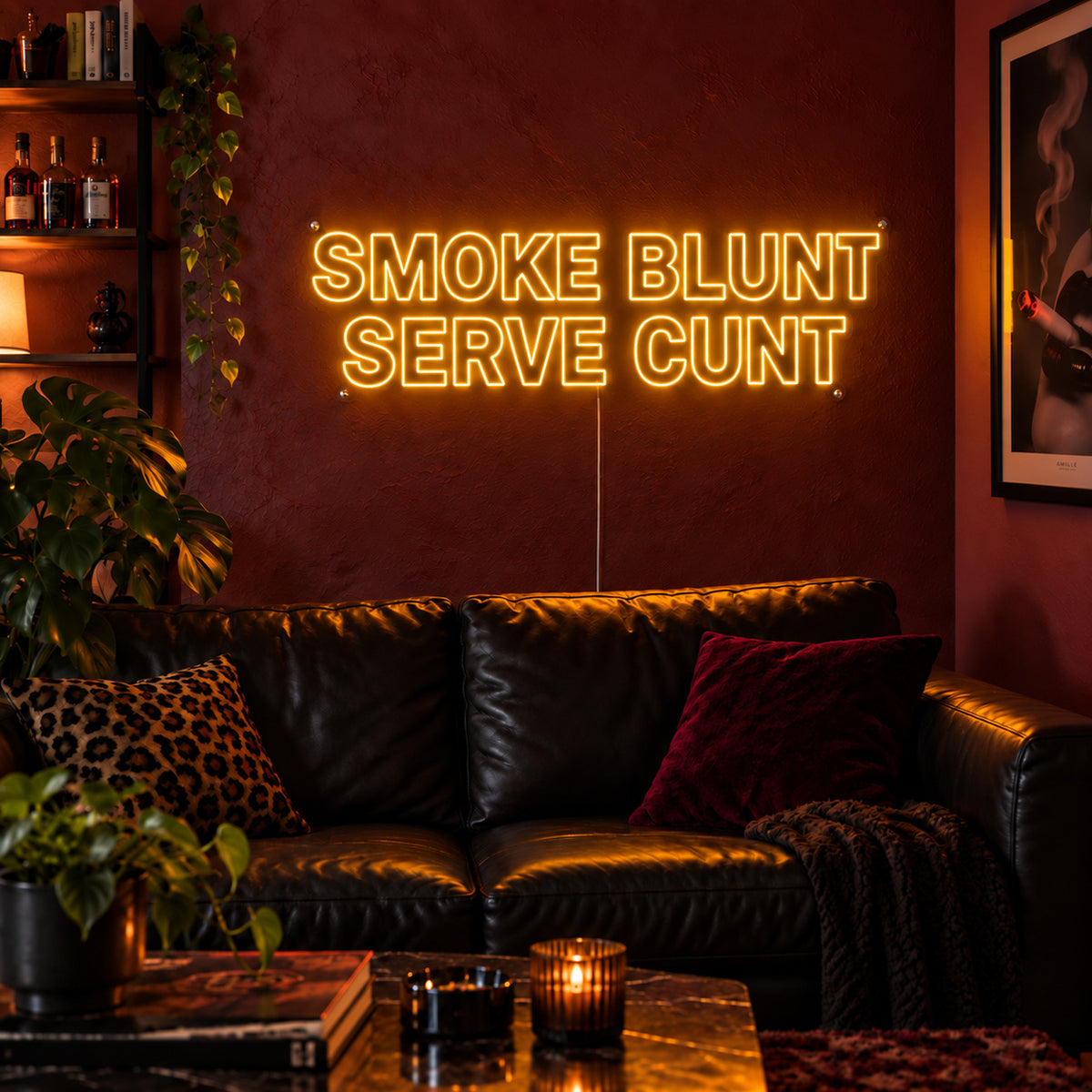 Smoke Blunt Serve Cunt Neon Sign glowing gold above a black leather sofa.