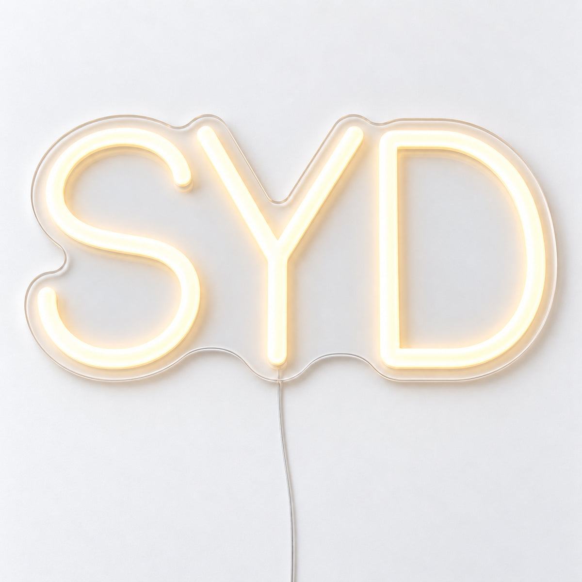 SYD Airport Code Neon Sign, featuring the SYD airport code in clean LED neon lettering, on a single clear acrylic backing displayed on a white surface.