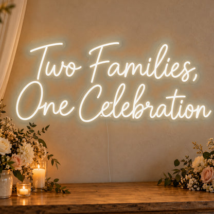 Two Families One Celebration Neon Sign in warm white LED neon on clear acrylic, angled view