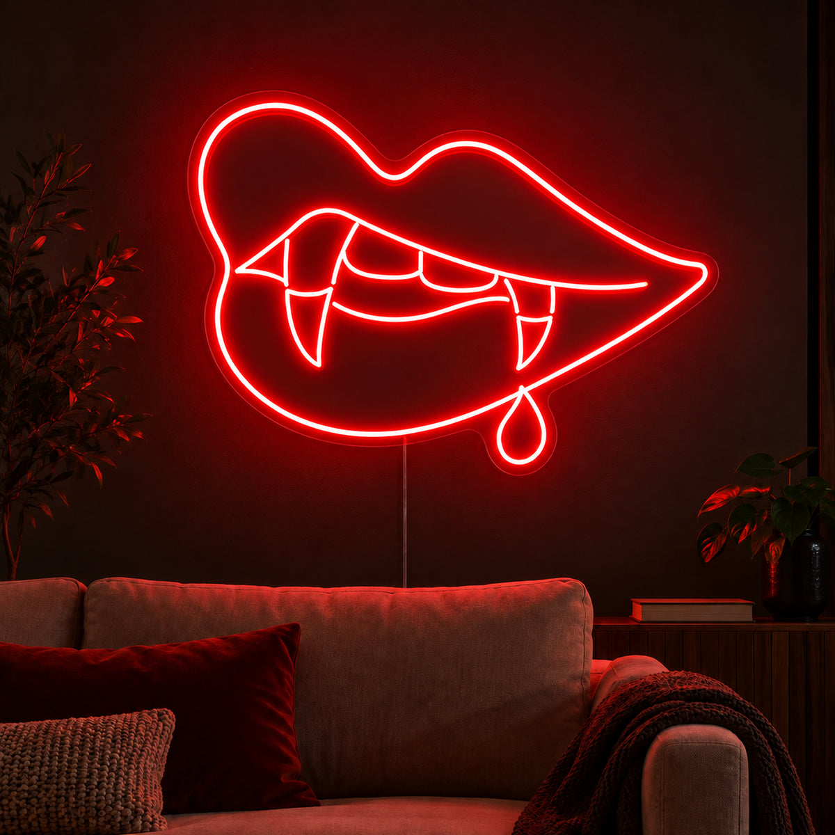 Vampire Lips with Single Blood Drop Neon Sign featuring red lips, pointed fangs and one hanging blood drop, glowing on a dark living room wall.