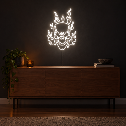 White Flaming Skull Neon Sign featuring a white skull surrounded by curling white flames, displayed on a dark wall above a wooden sideboard.