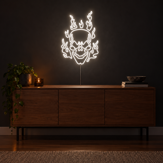 White Flaming Skull Neon Sign featuring a white skull surrounded by curling white flames, displayed on a dark wall above a wooden sideboard.