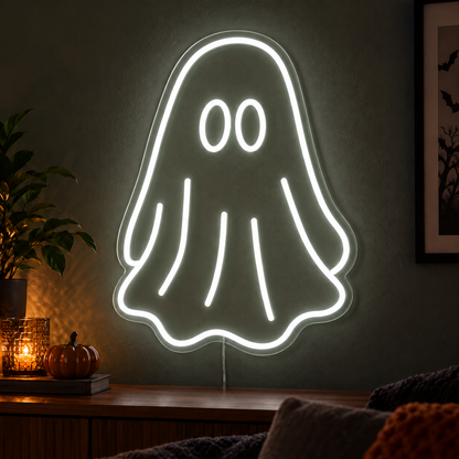 White Ghost Neon Sign featuring a white ghost outline with two oval eyes and a flowing sheet shaped body, displayed on a dark wall above a wooden sideboard.