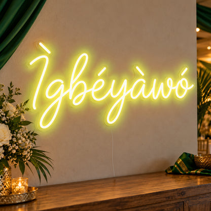 Ìgbéyàwó Yoruba Wedding Neon Sign in yellow LED neon on clear acrylic, angled view